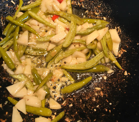 Add wild pepper and sour radish, add salt, and stir-fry to taste